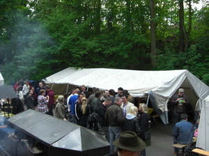 Ein Überblick über das Grillfest mit vielen Menschen - im Hintergrund steht ein Großzelt