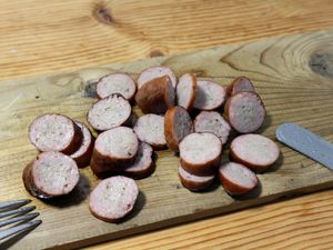Aufgeschnittene Smoked Sausage auf einem Holzbrett
