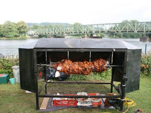 Spießgrill mit Windschutz an einem Fluss