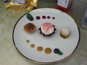 Dessertteller mit drei Törtchen, Beerenpunkten und Karamellsauce